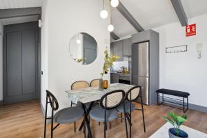 a dining room with a table and chairs at Limehome Madrid Calle de Santa Ana - estancia temporal in Madrid