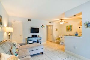 a living room with a couch and a tv at Less Than Half-Mi to St Pete Beach Condo with Pool! in St Pete Beach