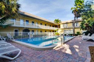 a swimming pool in front of a building at Less Than Half-Mi to St Pete Beach Condo with Pool! in St Pete Beach