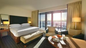 a hotel room with a bed and a large window at Hilton Dublin Kilmainham in Dublin