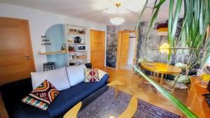 a living room with a blue couch and a table at Casa Ane - Gäste Apartment in Renningen