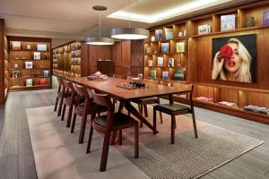 a dining room with a large wooden table and chairs at The Gabriel Miami Downtown, Curio Collection by Hilton in Miami