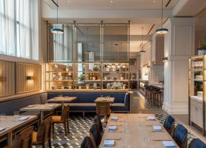 a restaurant with tables and chairs and a bar at Canopy By Hilton Philadelphia Center City in Philadelphia