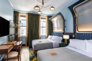 a hotel room with two beds and a desk at Canopy By Hilton Philadelphia Center City in Philadelphia