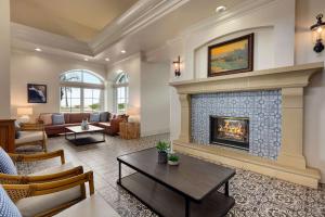 a living room with a fireplace and a couch at Hilton Garden Inn Carlsbad Beach in Carlsbad