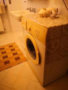 een wasmachine in een badkamer met een wastafel bij Villa Debora in Lucca