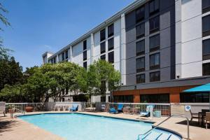 a swimming pool in front of a building at Hampton Inn Austin NW near The Domain in Austin
