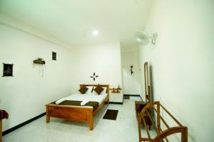 ein Schlafzimmer mit einem Bett in der Mitte eines Zimmers in der Unterkunft Dambulla Kings Inn in Dambulla