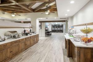a large kitchen with wooden cabinets and wooden floors at Hampton Inn Austin Round Rock in Round Rock
