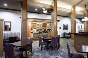 a dining room with wooden tables and purple chairs at Homewood Suites by Hilton Austin/Round Rock in Round Rock