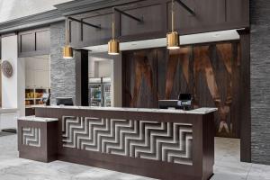 an office lobby with a reception desk with a maze pattern on the wall at Homewood Suites by Hilton Nashville Downtown in Nashville