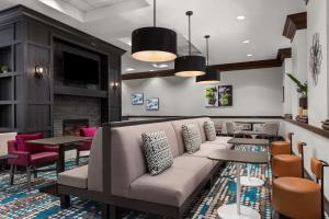 a lobby with a couch and tables and a fireplace at Homewood Suites by Hilton Nashville Downtown in Nashville