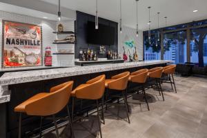 a bar with orange chairs at a restaurant at Homewood Suites by Hilton Nashville Downtown in Nashville
