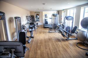 a gym with several treadmills and cardio machines at Best Western Brome Grange Hotel in Brome