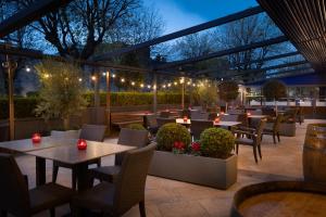 a restaurant with tables and chairs and lights at Hilton Dublin Kilmainham in Dublin