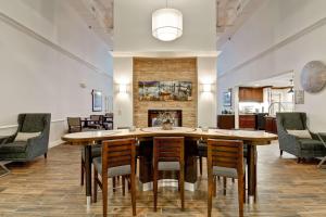 a dining room with a table and chairs and a fireplace at Homewood Suites by Hilton Newark-Cranford in Cranford