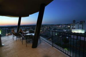 a balcony with a table and chairs on top of a building at Hilton Garden Inn Nashville Vanderbilt in Nashville
