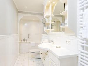 a white bathroom with a sink and a toilet at Hansenhoog-2 in Kampen