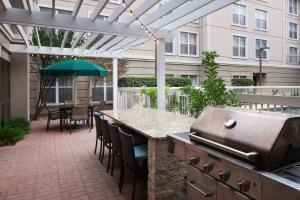 a patio with a grill and a table and chairs at Homewood Suites by Hilton Austin NW near The Domain in Austin