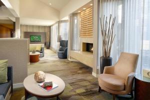 a lobby with a living room with a fireplace at Courtyard Charlotte SouthPark in Charlotte