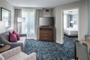 a hotel room with a couch and a television at Homewood Suites by Hilton Austin NW near The Domain in Austin