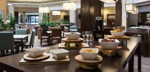 a restaurant with bowls of food on a table at Embassy Suites Denver Tech Center in Centennial