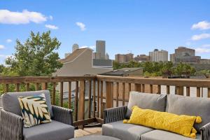 a patio with two chairs and a couch on a deck at Pittsburgh Gem - 5BR - Downtown Deck View in Pittsburgh