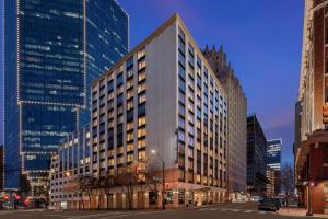 沃思堡Embassy Suites by Hilton Fort Worth Downtown的夜晚城市街道上的一栋高楼