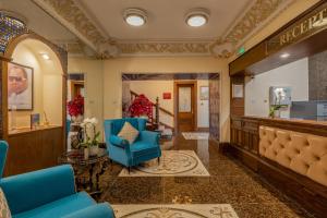 a lobby with a waiting room with a blue chair at Muthu Fort William Hotel in Fort William