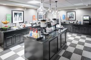a coffee shop with a counter in a room at Hampton Inn Los Angeles Orange County Cypress in Cypress