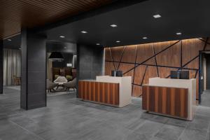 an office lobby with two reception desks and chairs at Courtyard By Marriott Titusville Kennedy Space Center in Titusville