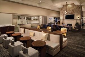 a lobby with a couch and tables and chairs at Homewood Suites by Hilton Lubbock in Lubbock