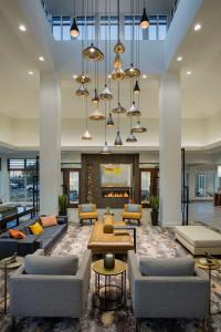 a lobby with couches and tables and a fireplace at Hilton Garden Inn Lubbock in Lubbock