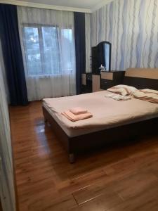 a bedroom with a bed with two towels on it at Apartament 1 in Batumi