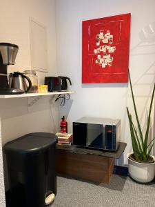 a microwave sitting on a table in a kitchen at Glads Apartment in Feldkirch