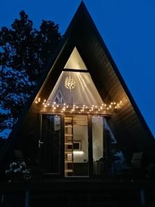 a house with lights on the roof at night at Rose Valley Cottage in Ieriķi