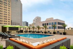 a pool on the roof of a building with buildings at Embassy Suites San Antonio Riverwalk-Downtown in San Antonio