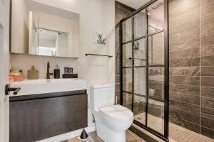 a bathroom with a toilet and a sink and a shower at Stylish Nexus in Columbus