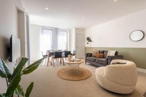 a living room with a couch and a table at Modern Apartments with Balcony in Merton near Wimbledon by Belvilla in Mitcham