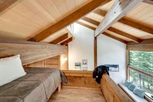 a bedroom in a tree house with a large window at 1 Mi to Northstar Village Pet-Friendly Condo! in Truckee