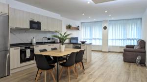 a kitchen and dining room with a table and chairs at Hydros Apartments - Bike Friendly in Ripoll