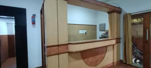 a bathroom with a large mirror and a door at Hotel Surya inn in Raipur