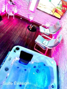 a hot tub in the middle of a room with chairs at Lovely in Neuf-Mesnil