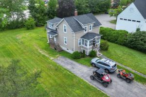 an aerial view of a house with a car and a motorcycle at Central & direct snowmobile access in Gorham