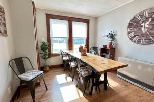 a dining room with a wooden table and chairs at Central & direct snowmobile access in Gorham