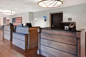an empty lobby with the american flag on the wall at Hampton Inn & Suites Alexandria Old Town Area South in Alexandria