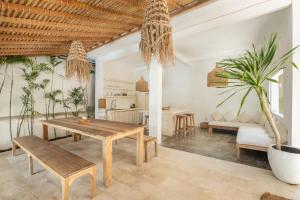 a living room with a wooden table and a couch at The Warm Sun - Bingin in Uluwatu