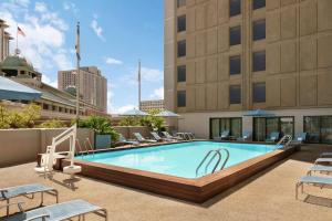 a swimming pool on the rooftop of a hotel at DoubleTree by Hilton New Orleans in New Orleans