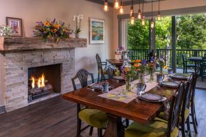 a dining room with a table and a fireplace at The Inn At Amaris Farms in Weaverville