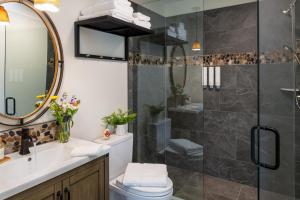 a bathroom with a shower and a toilet and a sink at The Inn At Amaris Farms in Weaverville